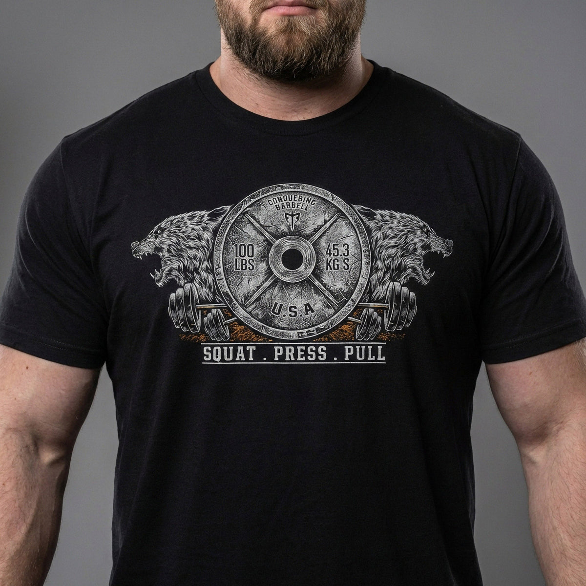 Conquering Barbell Dueling Bears tee in Black: two roaring grizzlies flanking an Olympic weight plate