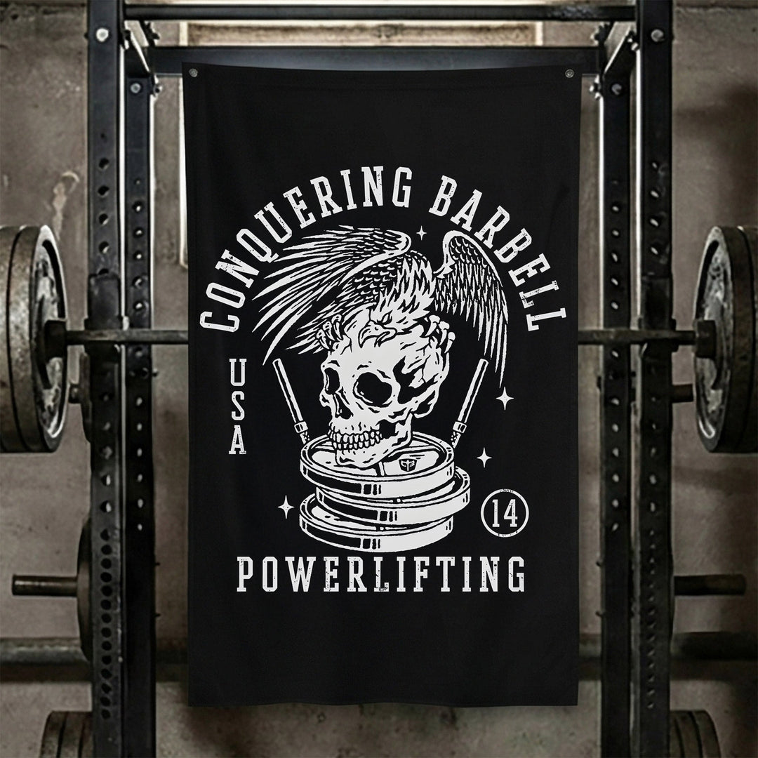 Conquering Barbell Eagle Powerlifting - Polyester Flag, vertical black gym flag with eagle perched on a skull atop stacked plates - Conquering Barbell
