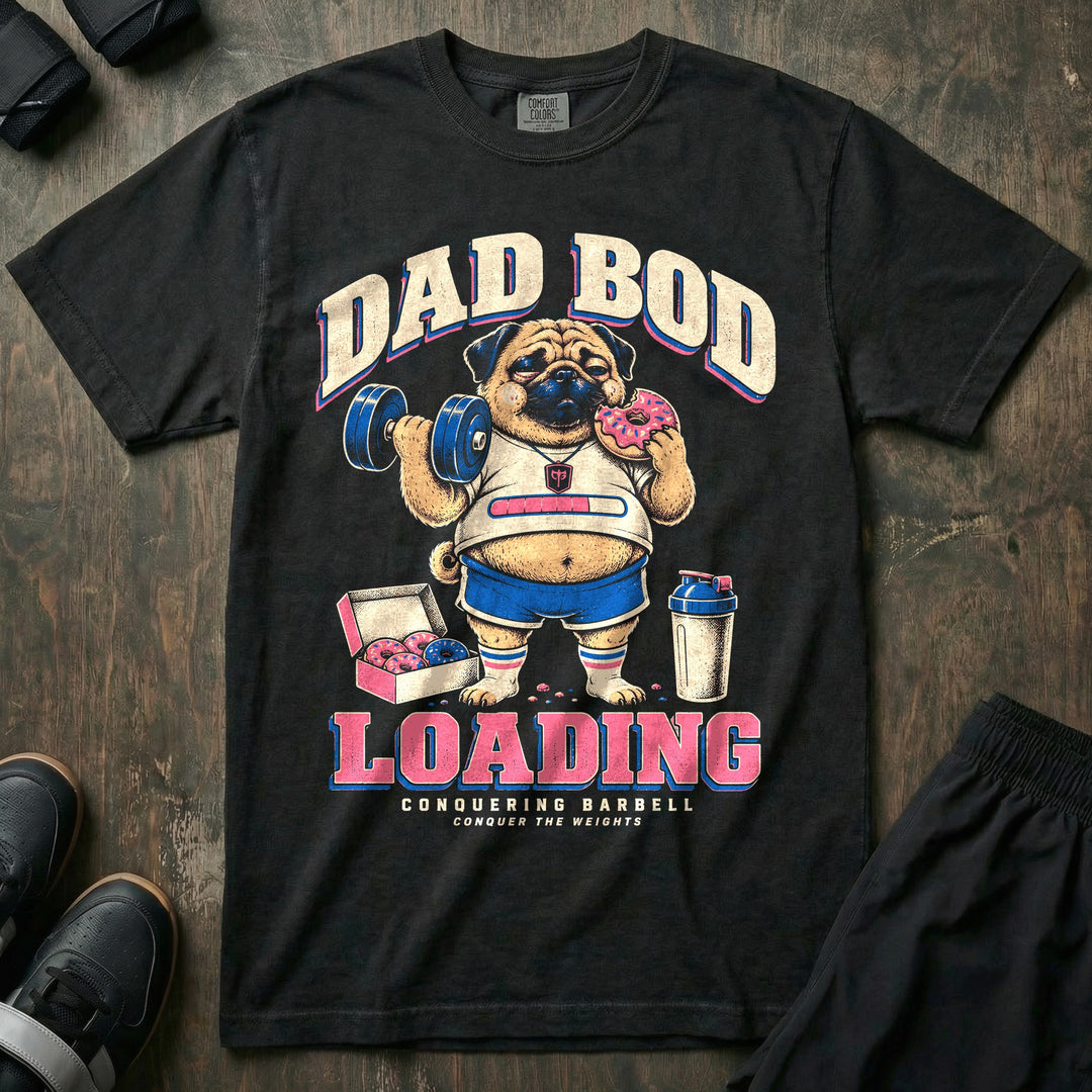Dad Bod Loading - Relaxed Fit Tee front graphic in Black with a chubby pug curling a dumbbell while eating a pink donut beside a box of donuts - Conquering Barbell