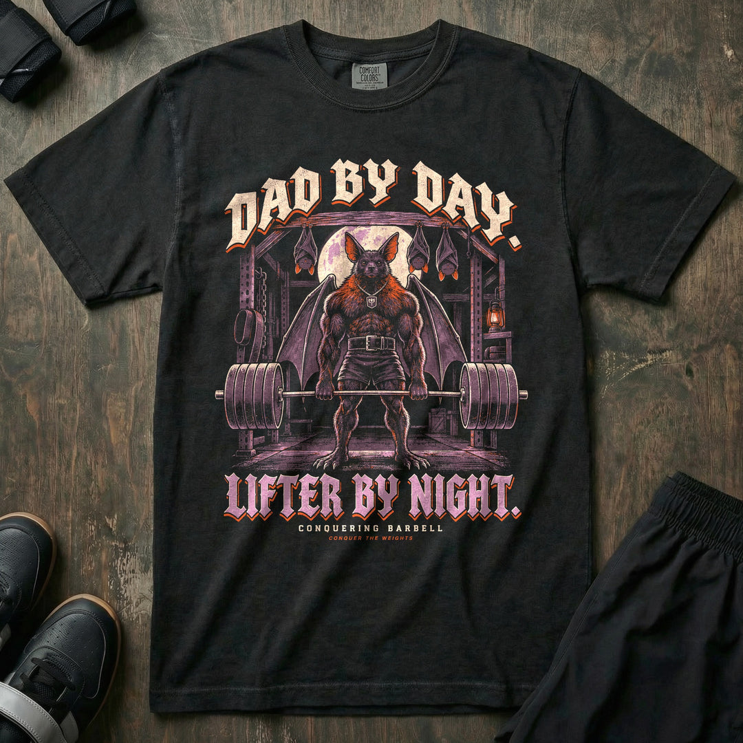Dad by Day. Lifter by Night - Relaxed Fit Tee front graphic in Black with a bat dad with spread wings deadlifting a loaded barbell under a full moon with three baby bats sleeping upside down above him - Conquering Barbell