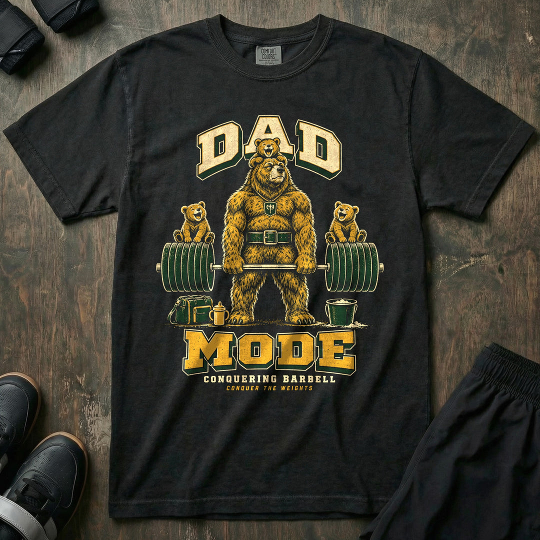 Dad Mode - Relaxed Fit Tee front graphic in Black with a grizzly bear dad deadlifting a loaded barbell with cubs sitting on the plates and on his head - Conquering Barbell