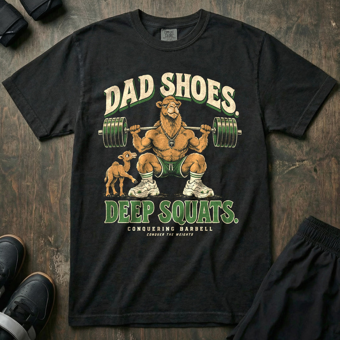 Dad Shoes. Deep Squats - Relaxed Fit Tee front graphic in Black with a camel dad in a deep squat with a loaded barbell wearing chunky white sneakers while a baby camel looks at his shoes - Conquering Barbell
