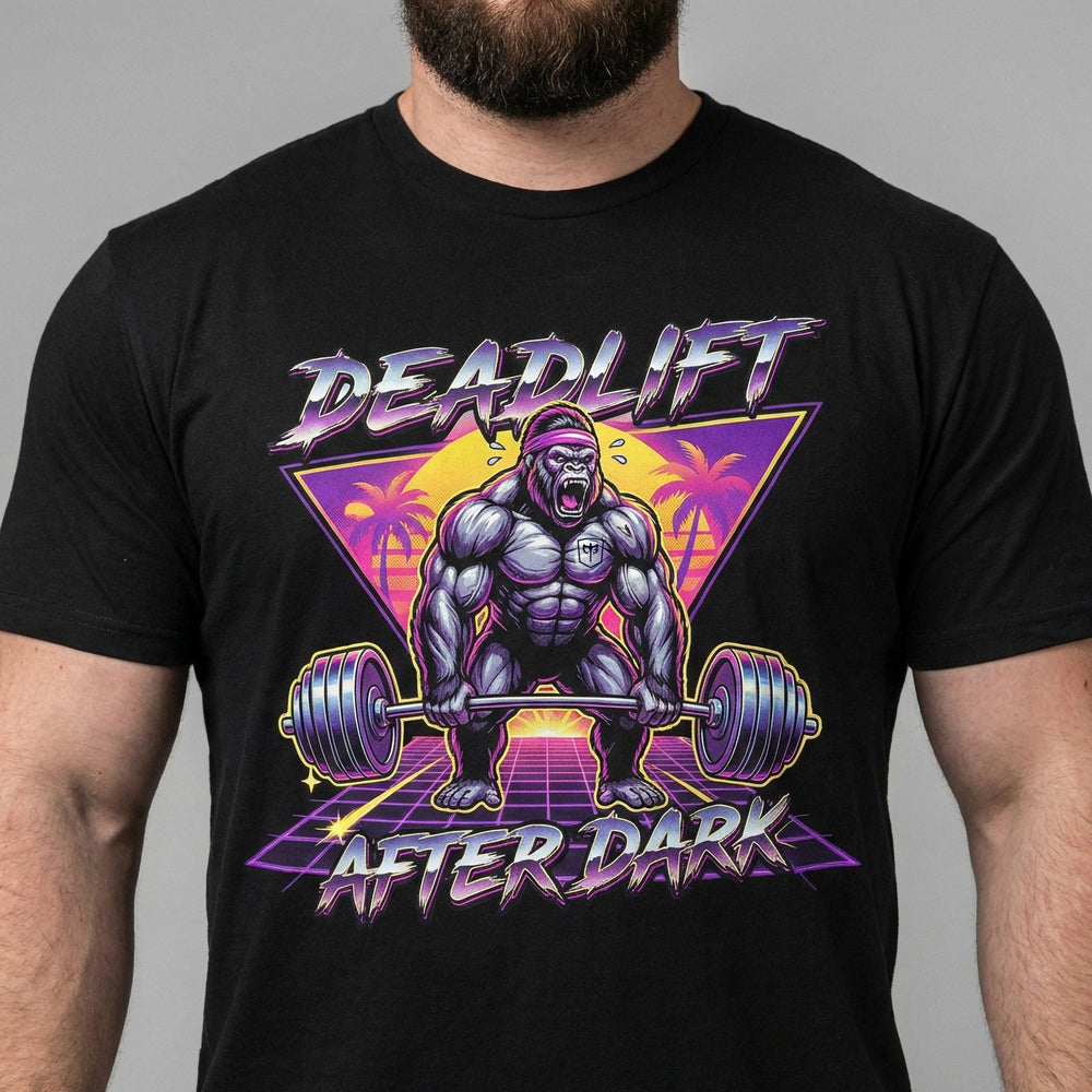Deadlift After Dark tee in Black: a retro 80s-style gorilla pulling heavy in front of a neon triangle and palm trees