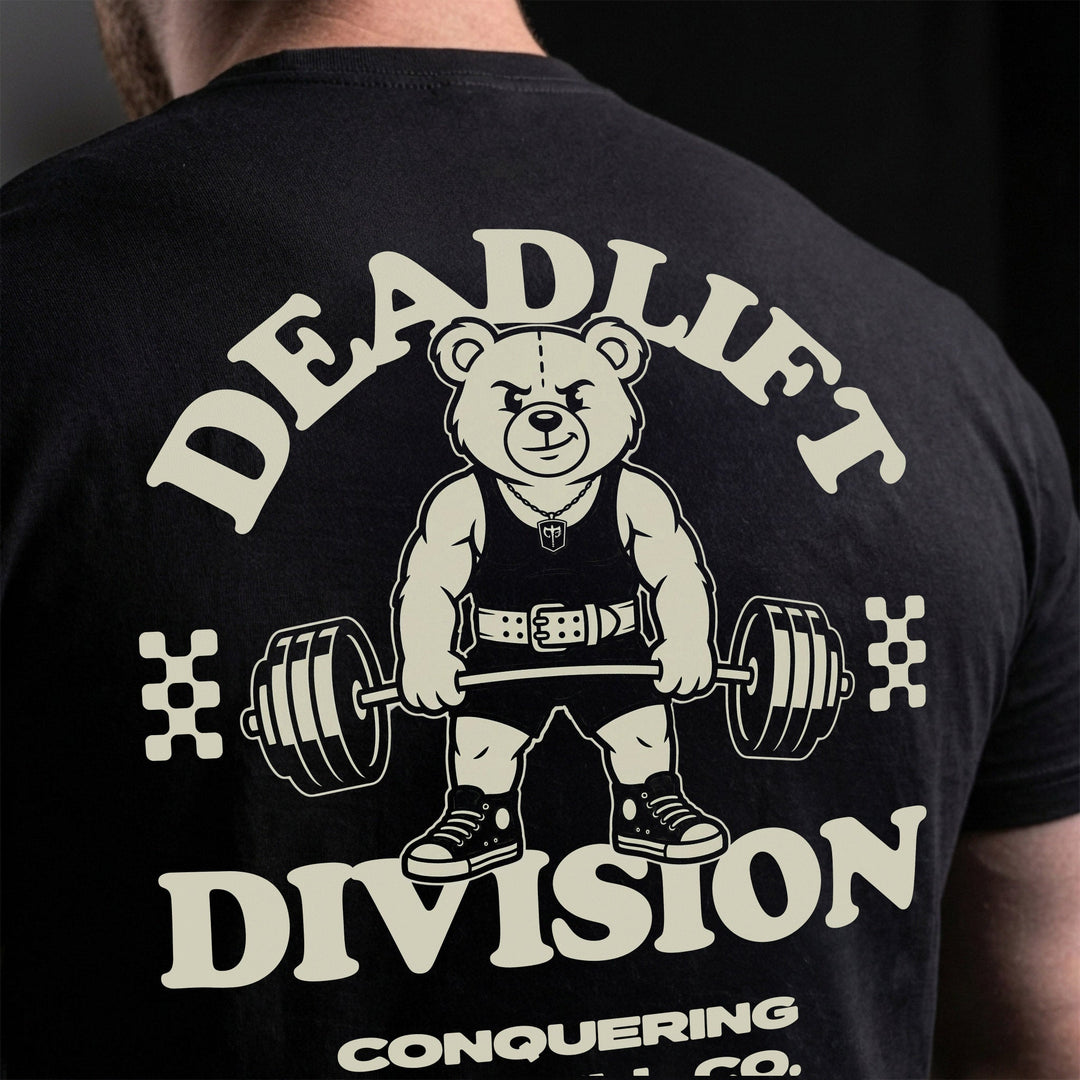Deadlift Division tee: a classic teddy bear pulling heavy in a lifting belt
