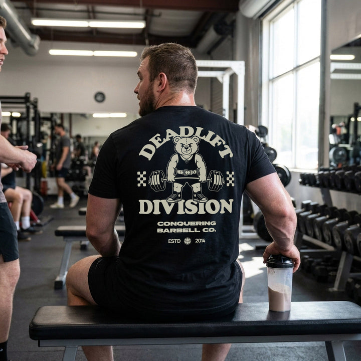 Deadlift Division tee: a classic teddy bear pulling heavy in a lifting belt