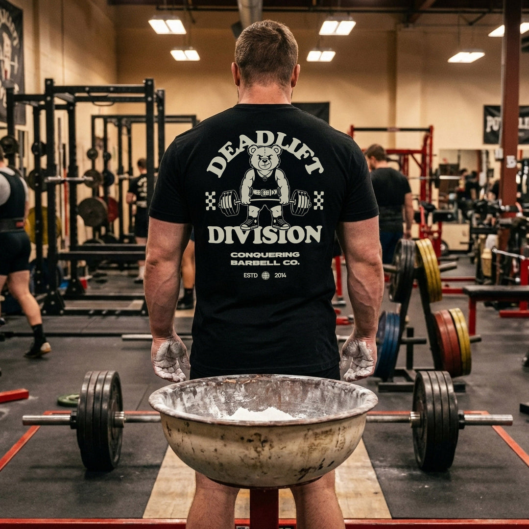 Deadlift Division tee: a classic teddy bear pulling heavy in a lifting belt