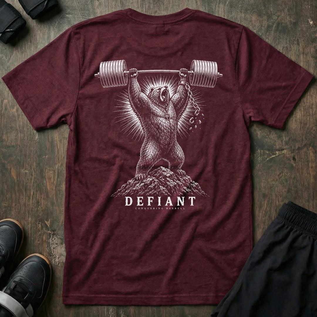 Defiant tee in Maroon: a grizzly standing atop a rocky summit