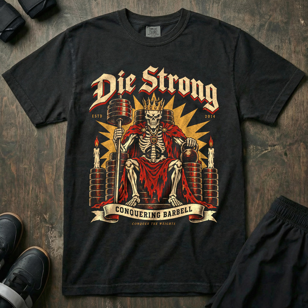 Die Strong - Relaxed Fit Tee front graphic in Black with a crowned skeleton king seated on a throne of weight plates - Conquering Barbell