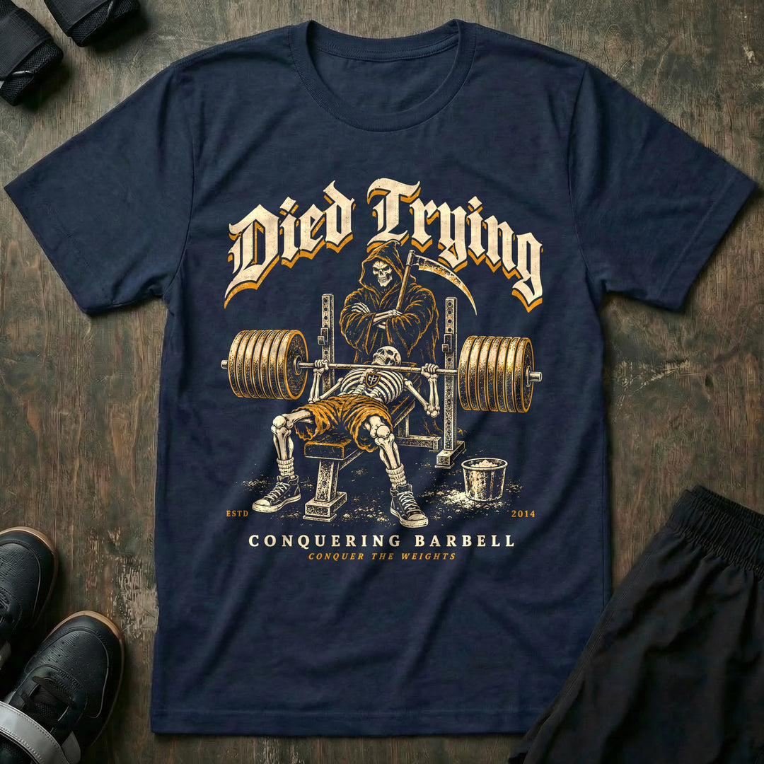 Died Trying - Tee front graphic in Navy with a skeleton pinned under a loaded bar on the bench while the Grim Reaper stands behind the rack with his arms crossed - Conquering Barbell