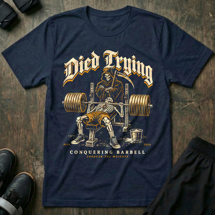 Died Trying - Tee front graphic in Navy with a skeleton pinned under a loaded bar on the bench while the Grim Reaper stands behind the rack with his arms crossed - Conquering Barbell