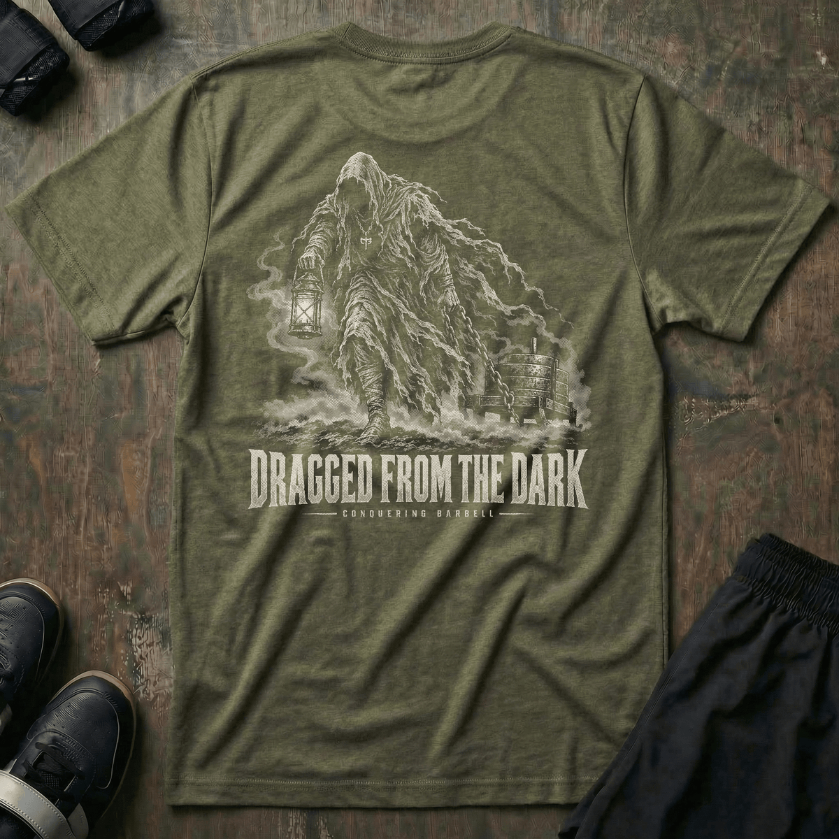 Dragged from the Dark tee in Military: a faceless hooded figure carrying a smoking lantern