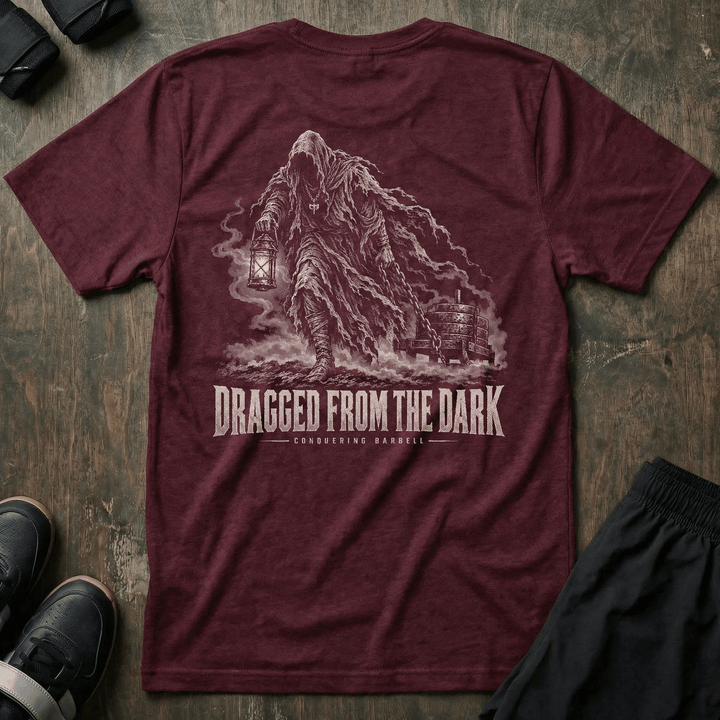 Dragged from the Dark tee in Maroon: a faceless hooded figure carrying a smoking lantern