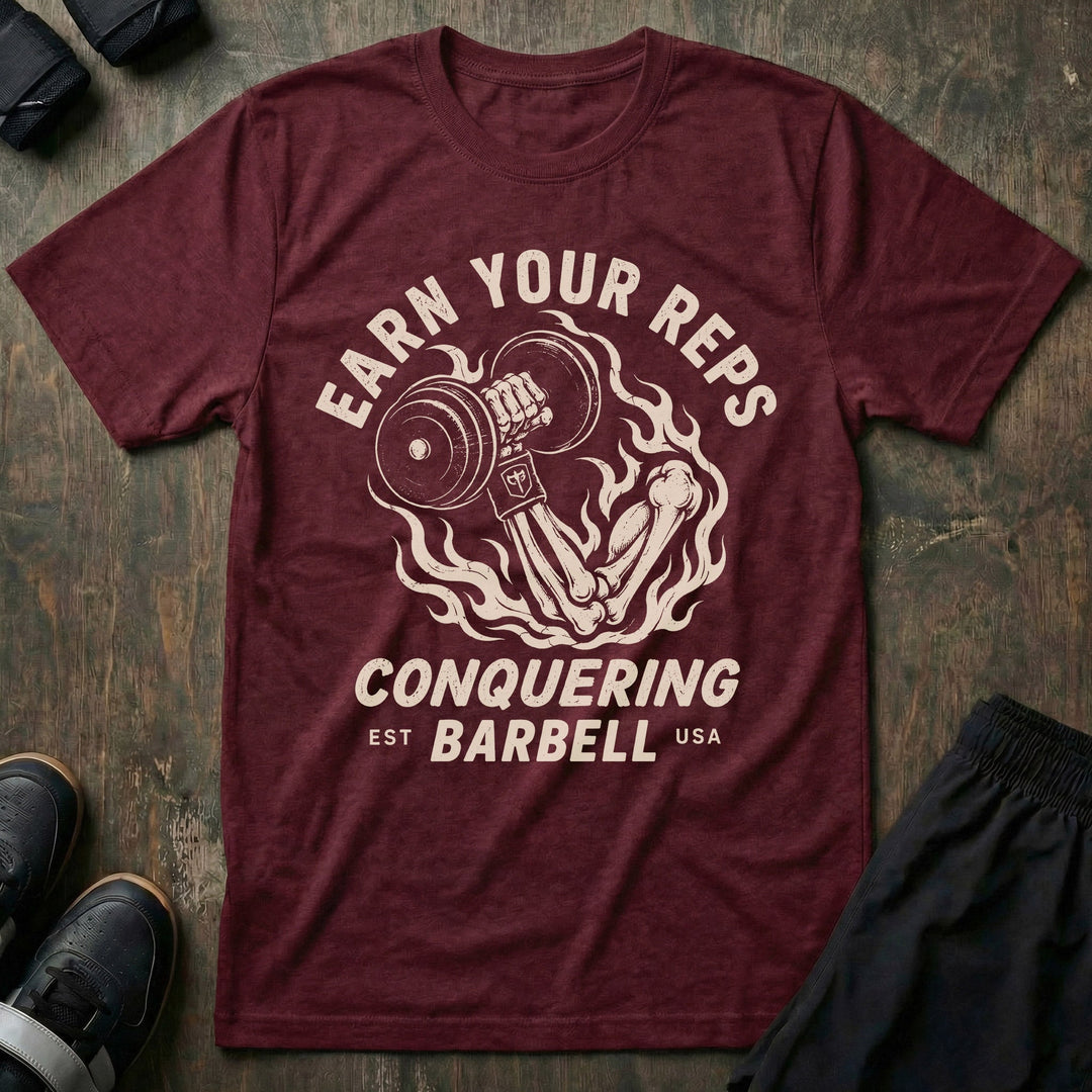 Earn Your Reps tee in Maroon: a skeletal hand rising from a ring of fire gripping a loaded dumbbell