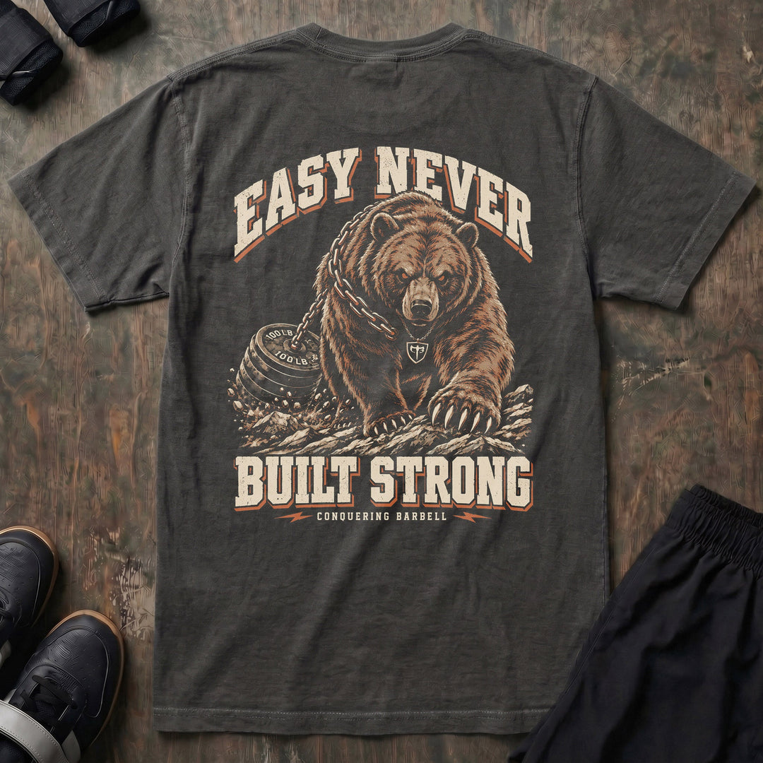 Easy Never Built Strong relaxed fit tee in Pepper: a massive grizzly driving forward