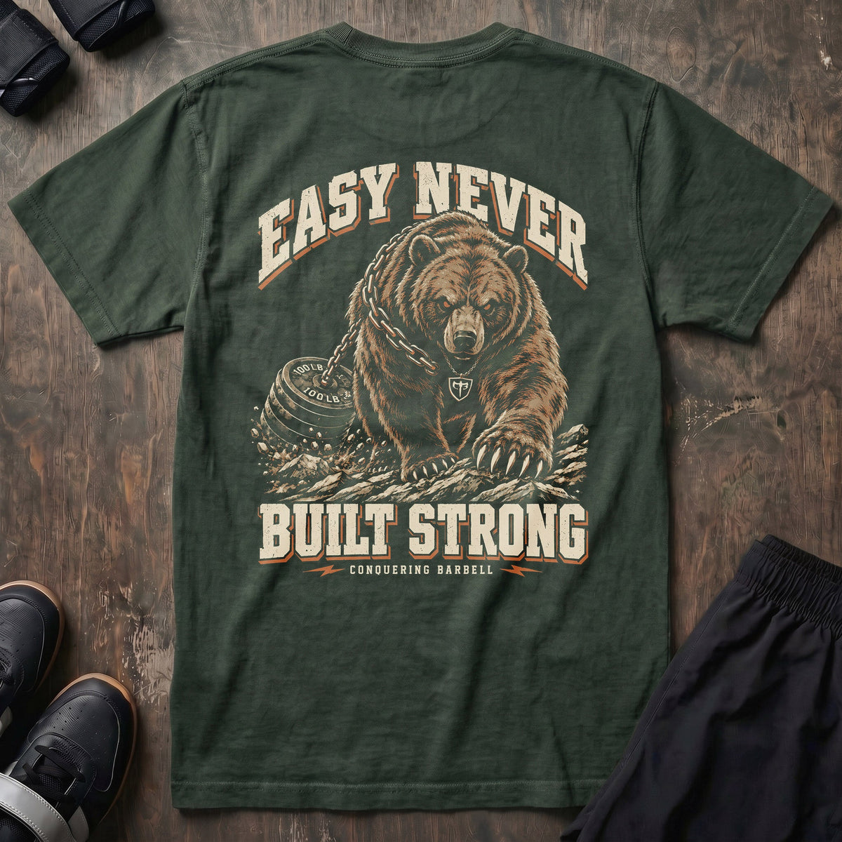 Easy Never Built Strong relaxed fit tee in Moss: a massive grizzly driving forward
