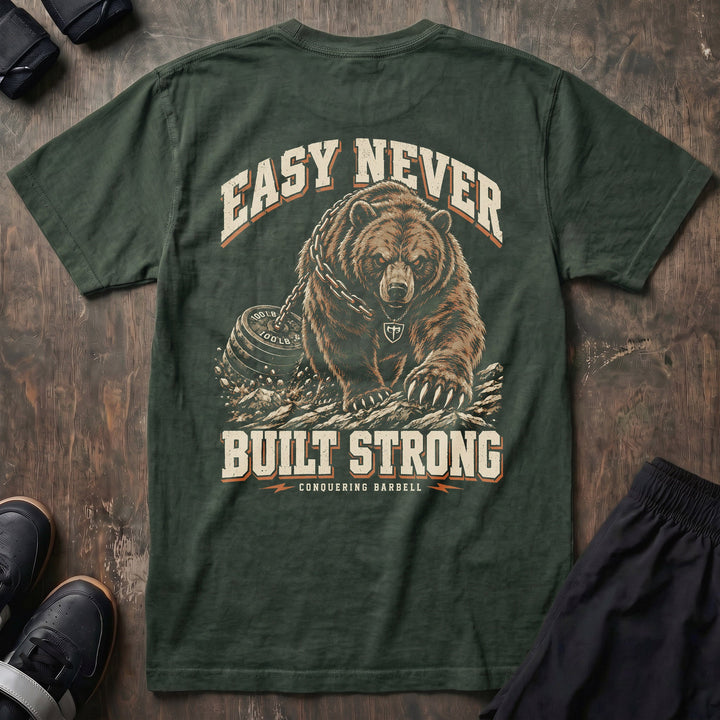 Easy Never Built Strong relaxed fit tee in Moss: a massive grizzly driving forward