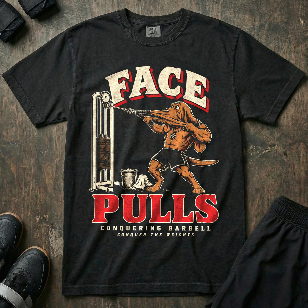 Face Pulls - Relaxed Fit Tee front graphic in Black with a bloodhound doing face pulls at a cable machine with his face stretched by the rope - Conquering Barbell