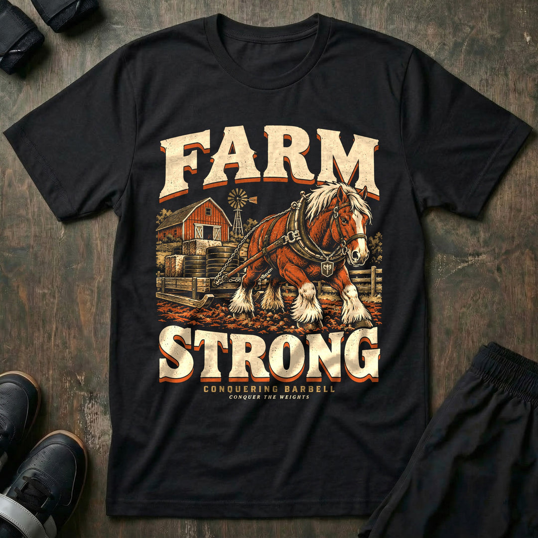 Farm Strong - Tee front graphic in Black with a draft horse dragging a sled stacked with weight plates past a red barn - Conquering Barbell