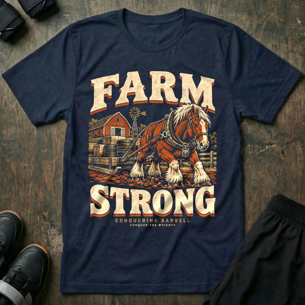 Farm Strong - Tee front graphic in Navy with a draft horse dragging a sled stacked with weight plates past a red barn - Conquering Barbell