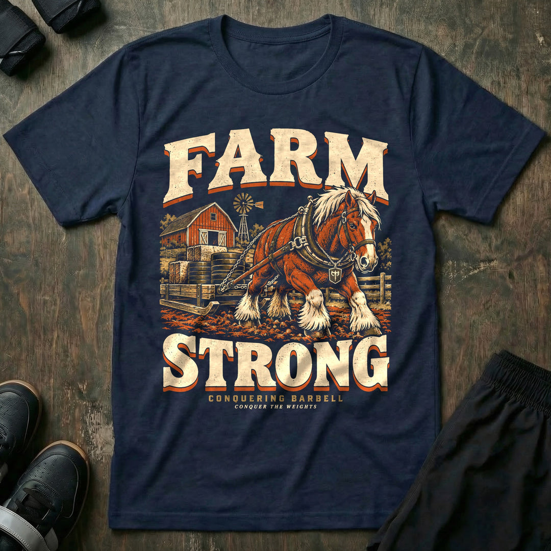 Farm Strong - Tee front graphic in Navy with a draft horse dragging a sled stacked with weight plates past a red barn - Conquering Barbell