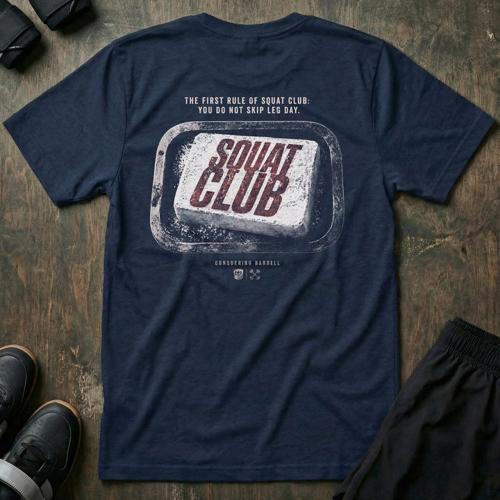 First Rule tee in Navy: a worn chalk block stamped with SQUAT CLUB in bold red lettering