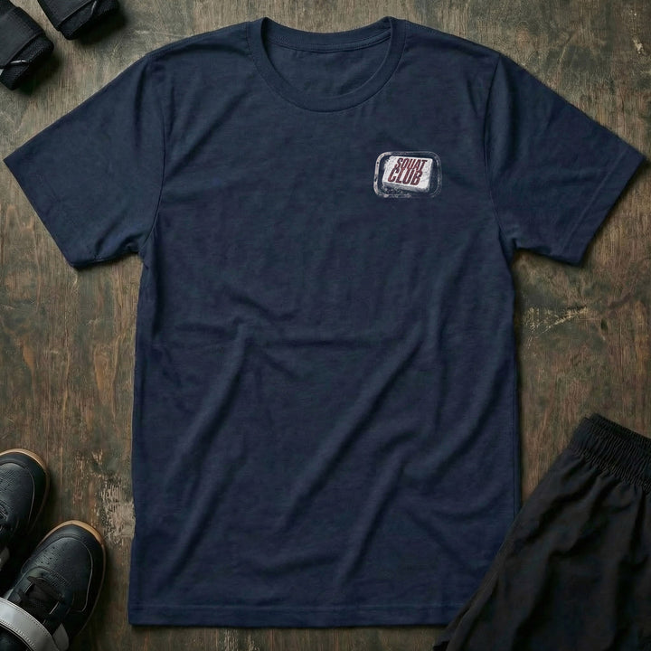 First Rule tee: a worn chalk block stamped with SQUAT CLUB in bold red lettering