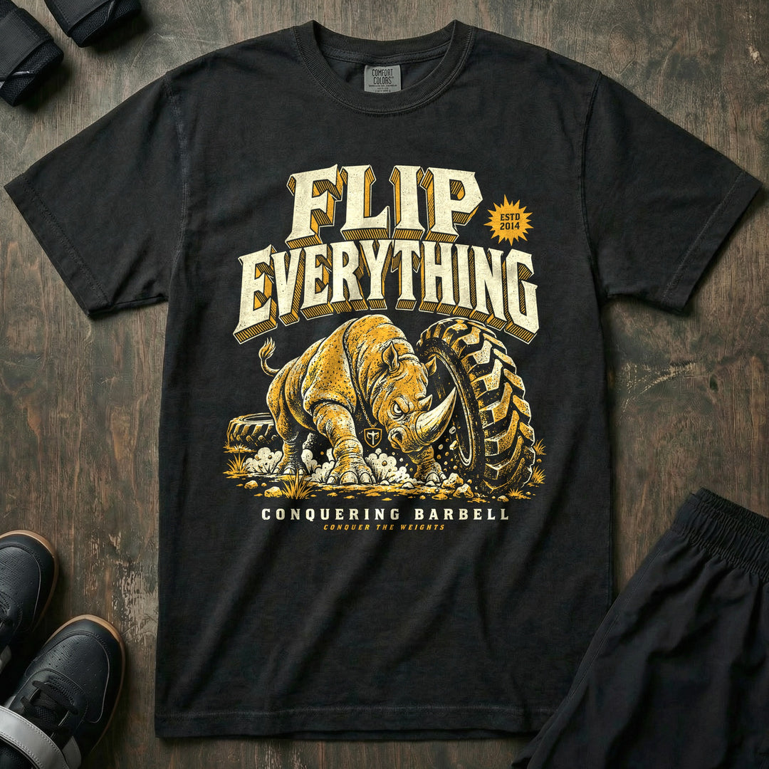 Flip Everything - Relaxed Fit Tee front graphic in Black with a rhino flipping a giant tractor tire - Conquering Barbell