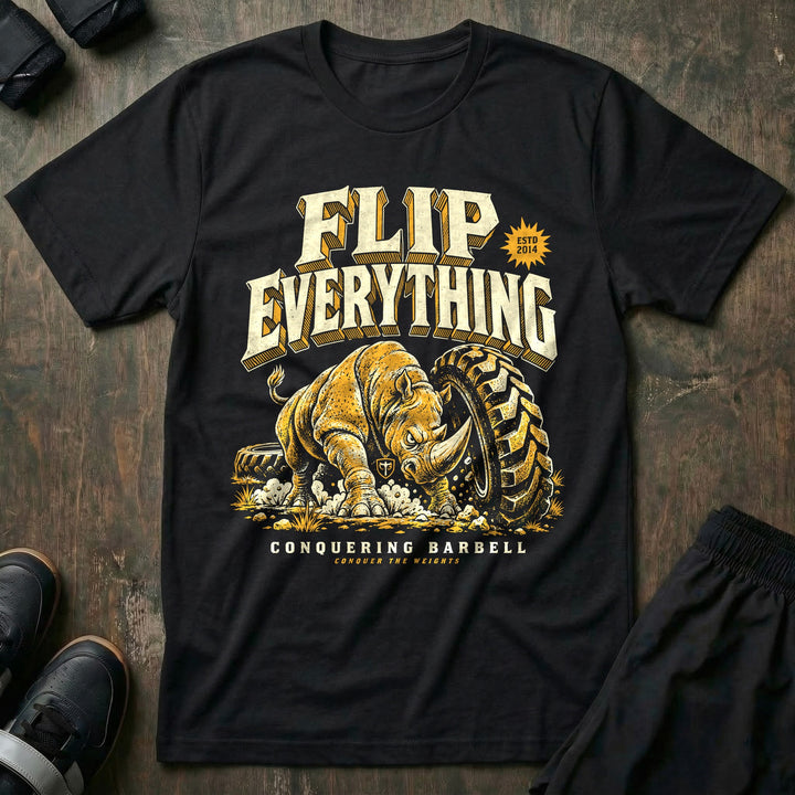 Flip Everything - Tee front graphic in Black with a rhino flipping a giant tractor tire - Conquering Barbell