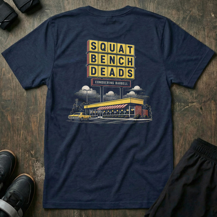 Gainz House tee in Navy: a retro diner sign stacked with SQUAT BENCH DEADS in bold yellow lettering