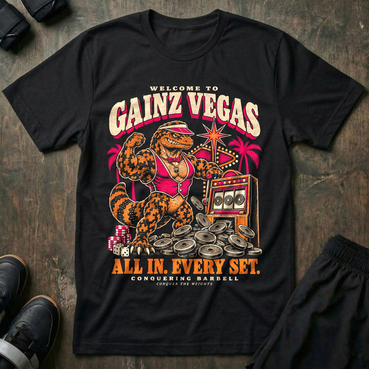 Gainz Vegas - Tee front graphic in Black with a lounge lizard in a pink vest hitting a slot machine jackpot of weight plates - Conquering Barbell
