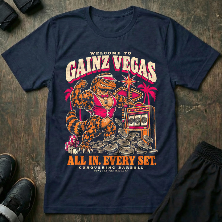 Gainz Vegas - Tee front graphic in Navy with a lounge lizard in a pink vest hitting a slot machine jackpot of weight plates - Conquering Barbell