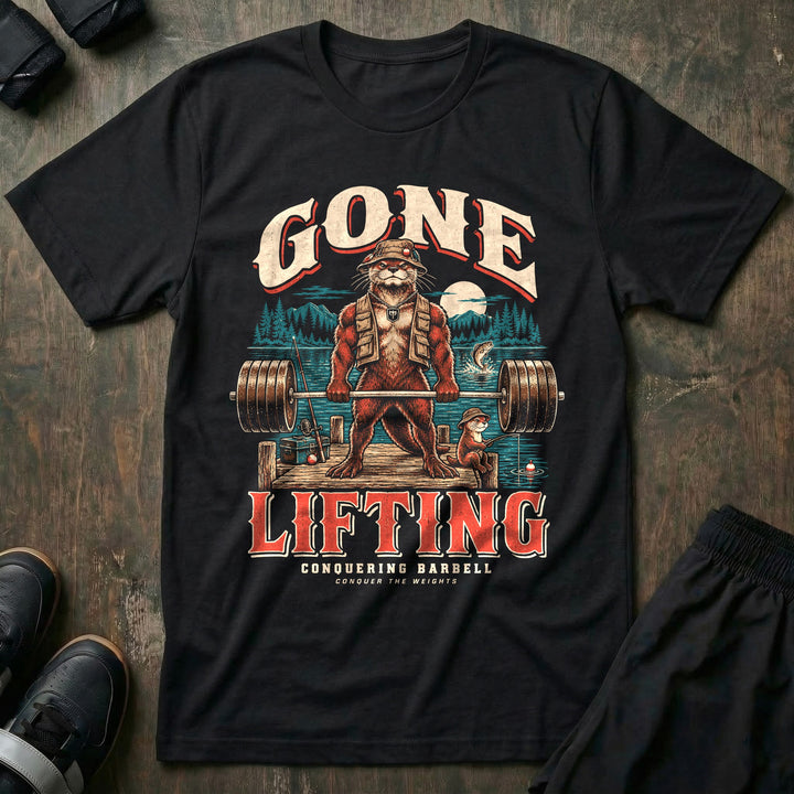 Gone Lifting - Tee front graphic in Black with an otter dad in a bucket hat and fishing vest deadlifting a loaded barbell on a lake dock while a young otter fishes - Conquering Barbell