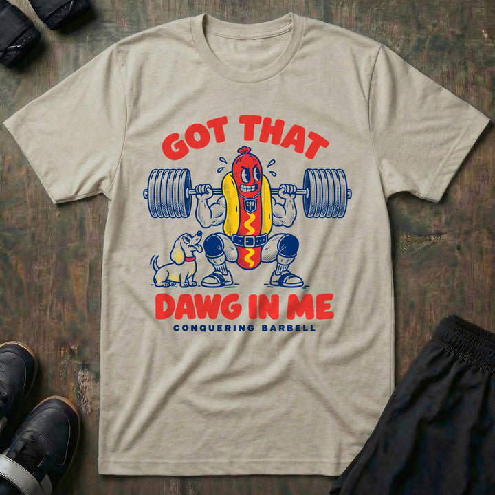 Got That Dawg in Me - Tee front graphic in Sand with a hot dog in a bun back squatting a loaded barbell while a dachshund watches - Conquering Barbell
