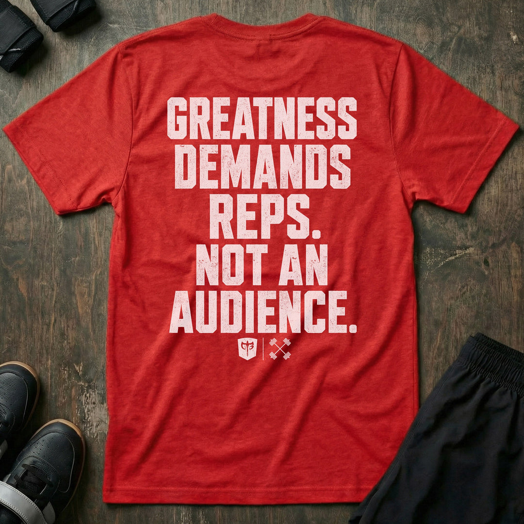 Greatness Demands Reps. Not an Audience. tee in Red: the full statement in oversized distressed block lettering stacked down