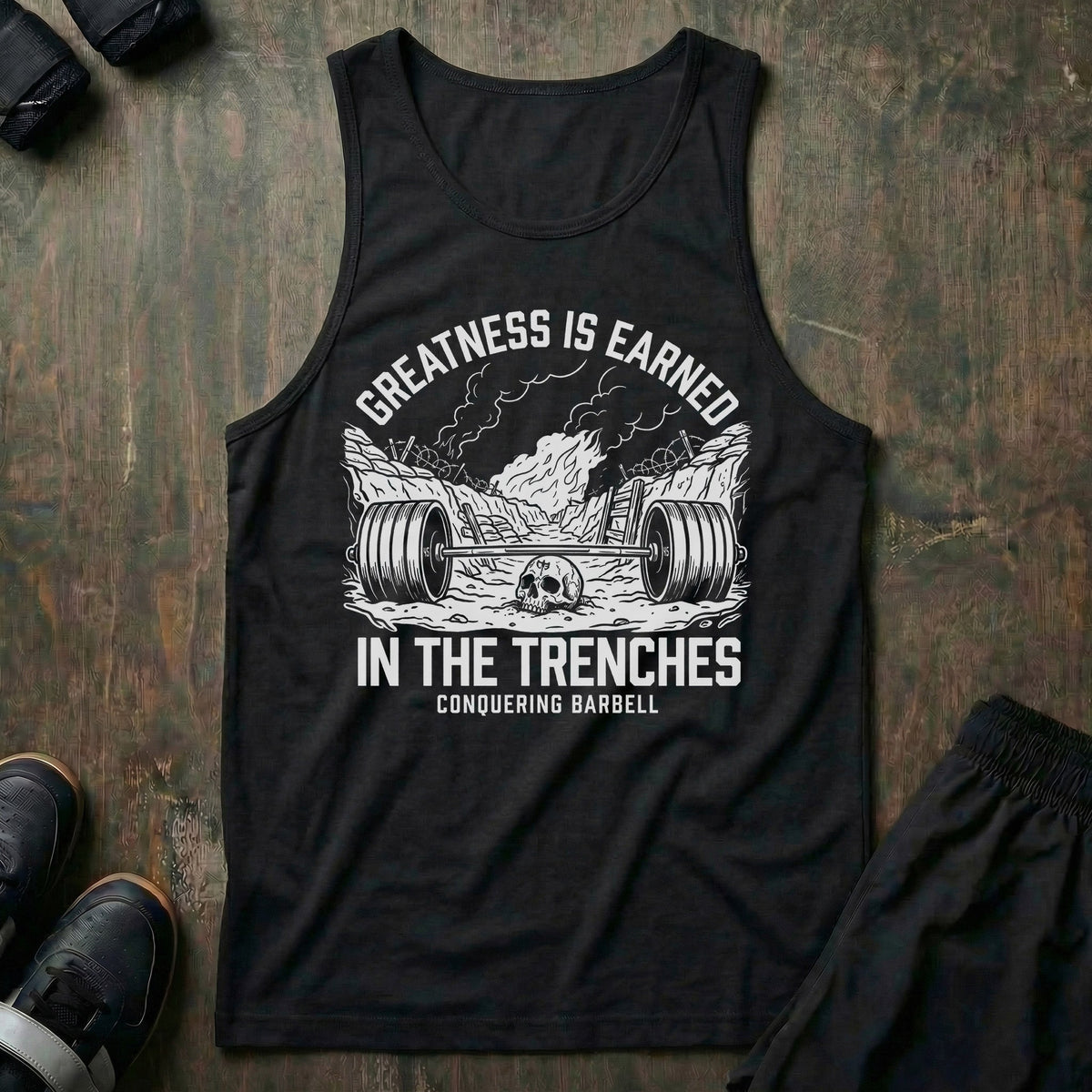 Greatness is Earned in the Trenches tank top in Black: a loaded barbell lying in a war trench