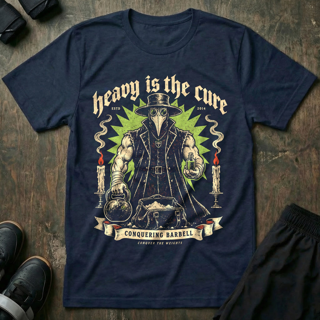 Heavy Is the Cure - Tee front graphic in Navy with a muscular plague doctor holding a kettlebell and a vial - Conquering Barbell