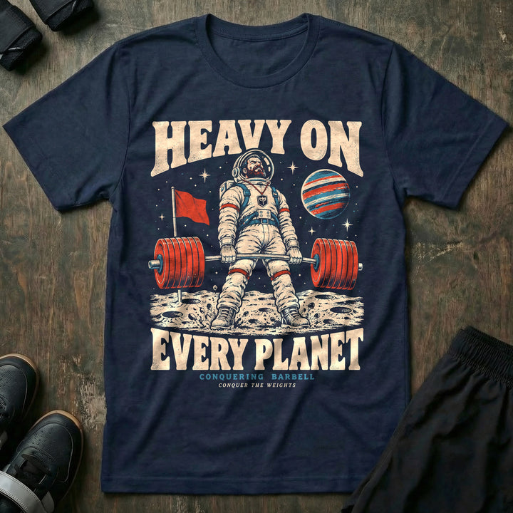 Heavy on Every Planet - Tee front graphic in Navy with a bearded astronaut deadlifting a loaded barbell on the moon - Conquering Barbell
