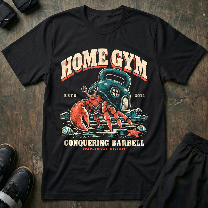 Home Gym - Tee front graphic in Black with a hermit crab living inside a kettlebell on the beach - Conquering Barbell