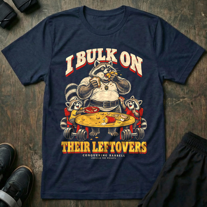 I Bulk on Their Leftovers - Tee front graphic in Navy with a heavyset raccoon dad eating a sandwich and nuggets at the kids&