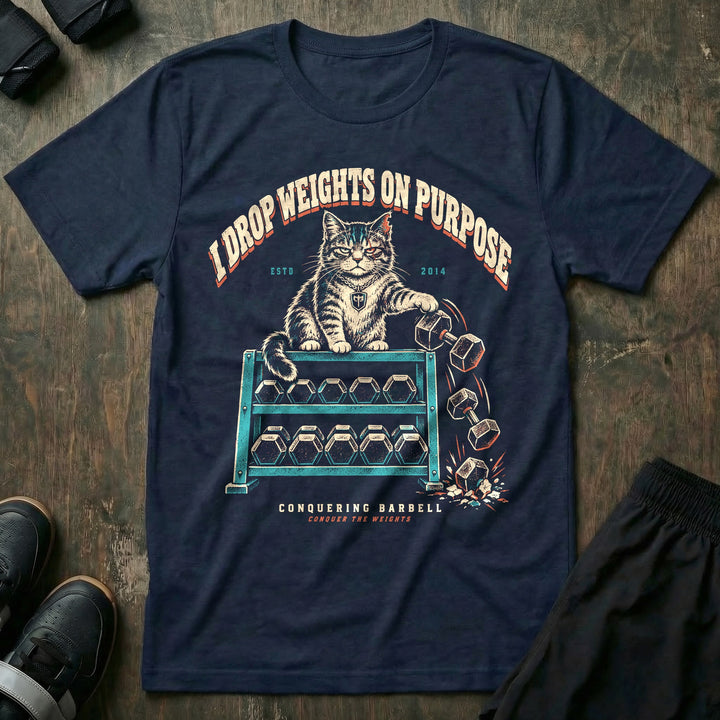 I Drop Weights on Purpose - Tee front graphic in Navy with a tabby cat pushing dumbbells off a dumbbell rack - Conquering Barbell
