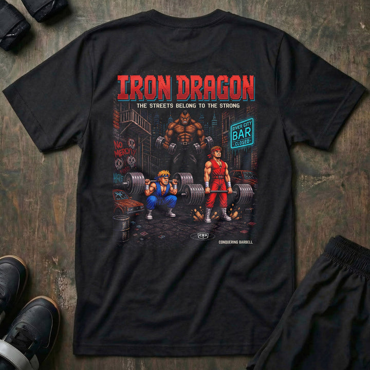 Iron Dragon tee in Black: a pixel-art street scene with two fighters squatting and deadlifting loaded barbells