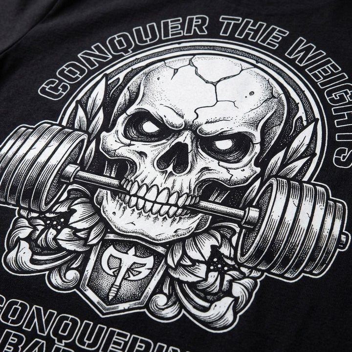 Iron Reaper tee in Black: a cracked skull biting down on a barbell