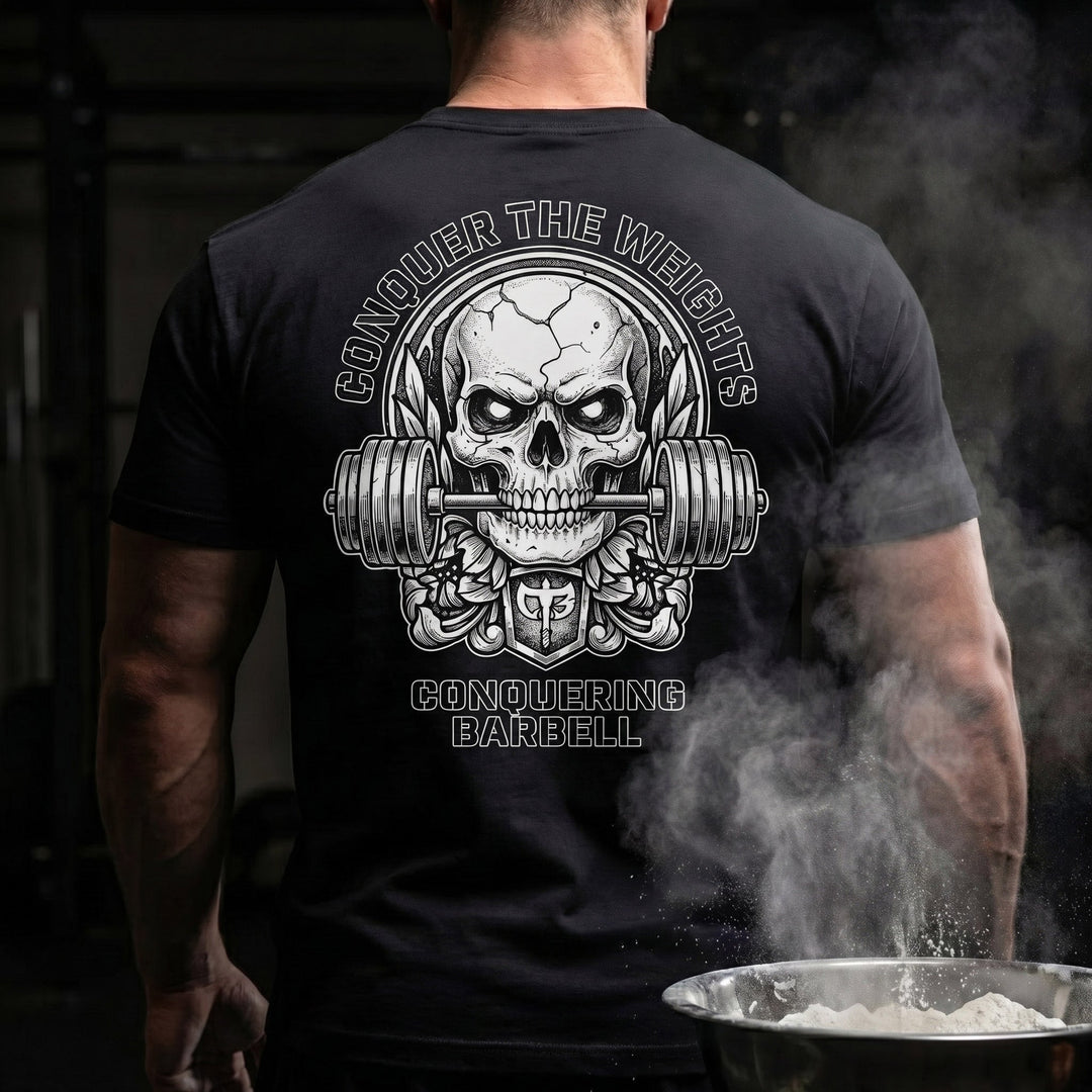 Iron Reaper tee in Black: a cracked skull biting down on a barbell
