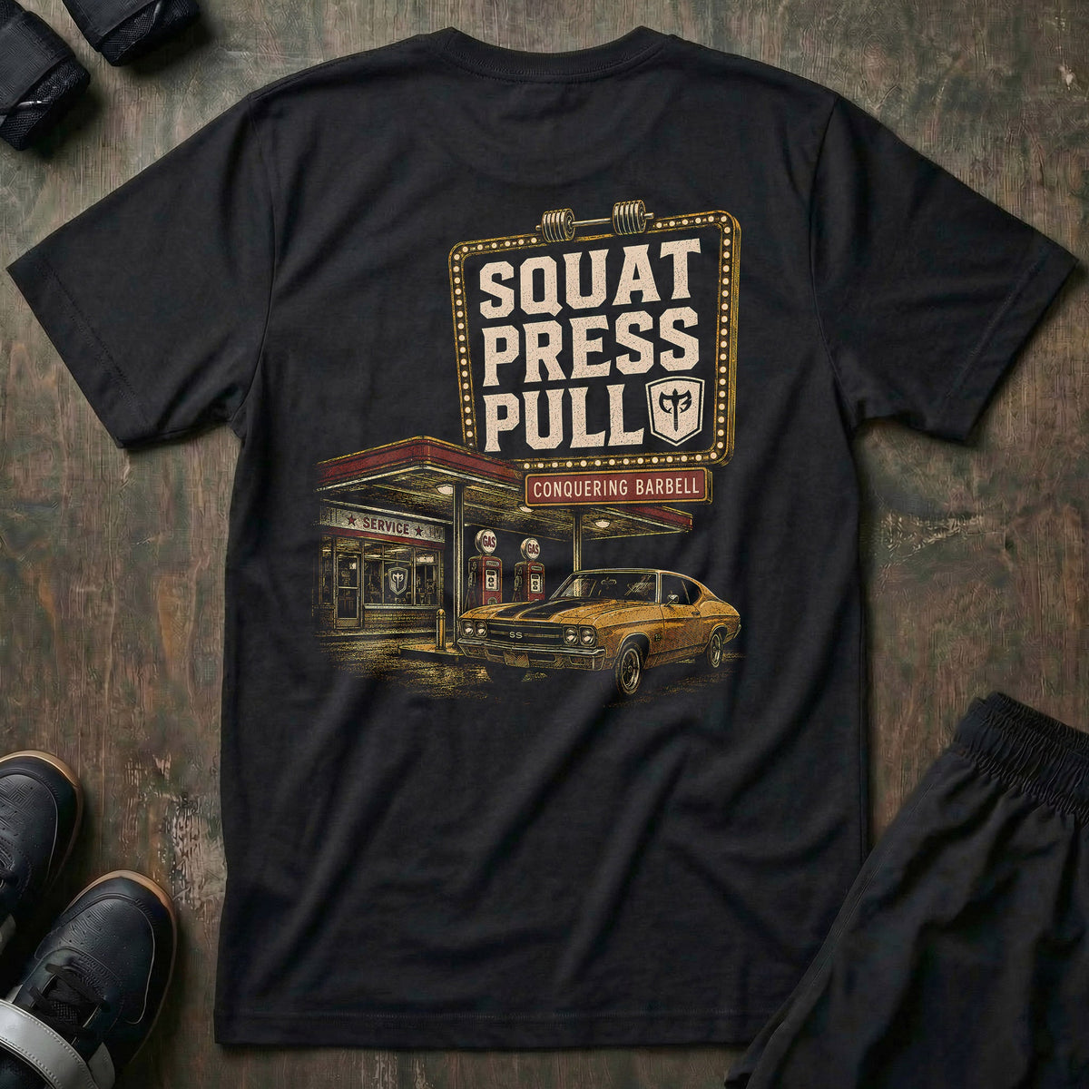 Iron Station tee in Black: a vintage marquee sign framed in bulb lights reading SQUAT PRESS PULL