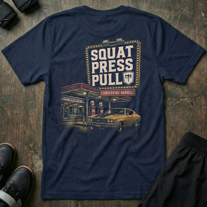 Iron Station tee in Navy: a vintage marquee sign framed in bulb lights reading SQUAT PRESS PULL