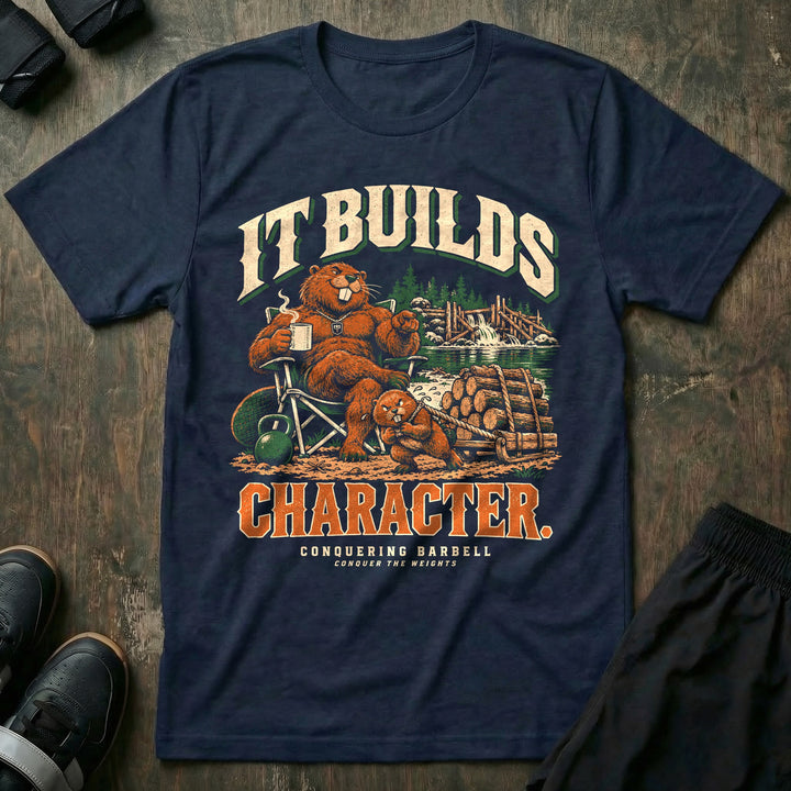 It Builds Character - Tee front graphic in Navy with a beaver dad sitting in a camp chair with coffee while a young beaver pulls a sled loaded with logs near a dam - Conquering Barbell
