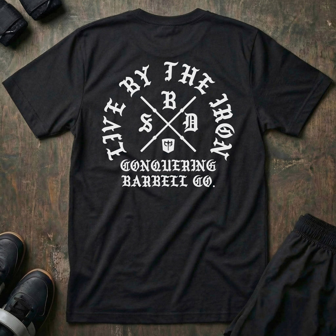Live by the Iron tee in Black: a circular old English LIVE BY THE IRON design built around two crossed barbell sleeves