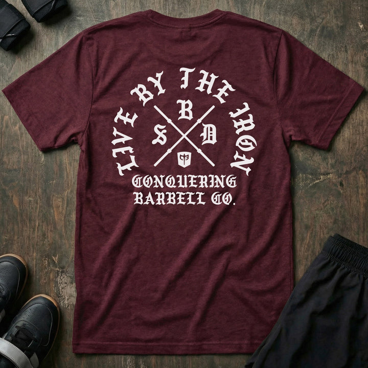 Live by the Iron tee in Maroon: a circular old English LIVE BY THE IRON design built around two crossed barbell sleeves