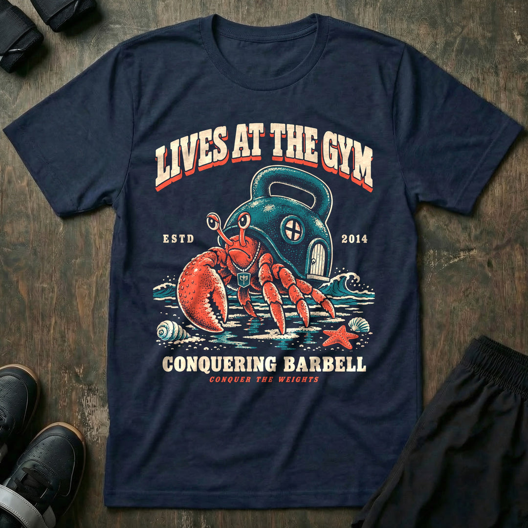 Lives at the Gym - Tee front graphic in Navy with a hermit crab living inside a kettlebell on the beach - Conquering Barbell