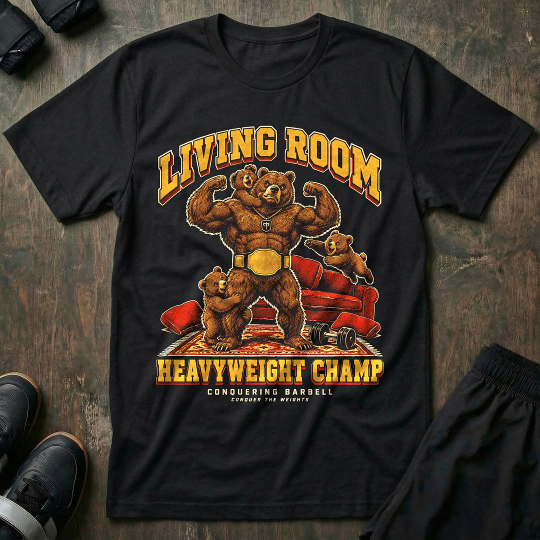 Living Room Heavyweight Champ - Tee front graphic in Black with a brown bear dad flexing in a gold championship belt while three bear cubs climb on him in a living room - Conquering Barbell